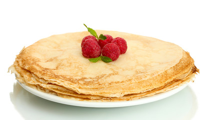 Delicious pancakes with raspberries on plate isolated on white