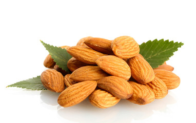 tasty almonds nuts with leaves, isolated on white