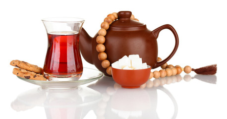 glass of Turkish tea and kettle isolated on white