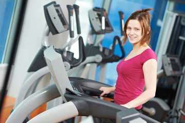 Fototapeta na wymiar positive woman at cardio training simulator