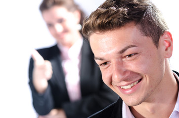 Portrait of young business man with his colleague at the back