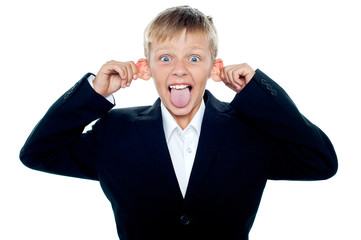 Notorious little boy making faces and teasing