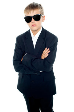 Snapshot of young kid wearing suit and sunglasses