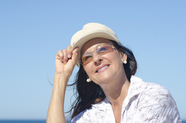 Attractive mature woman sky background