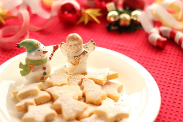 Christmas ornaments and homemade cookies on red table