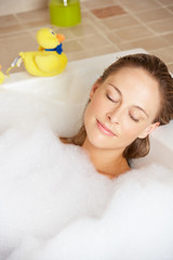 Woman Relaxing In Bubble Filled Bath