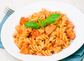 Fusilli pasta with chicken breast in tomato sauce
