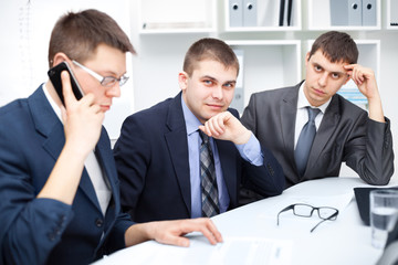 Team of young business men working together at office