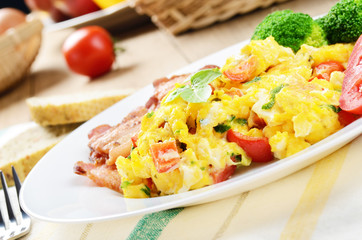 Omelette with vegetables and fried bacon