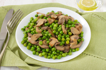 green peas with mushrooms on the plate