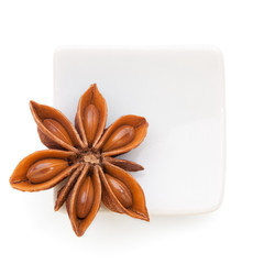 Anise star (Illicium verum)  in a white bowl on white background
