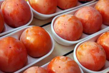 Persimmon in polystyrene trays