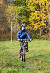 Fototapeta premium Kid cycling in a park