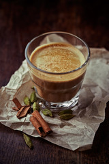 Glass of aromatic coffee with milk and spices