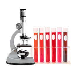 Medical test tubes with blood in holder and microscope on white