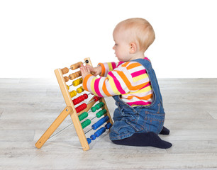 Cute baby girl playing with an abacus