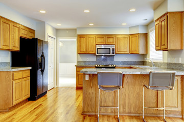 New classic kitchen with bar stools and hardwood.