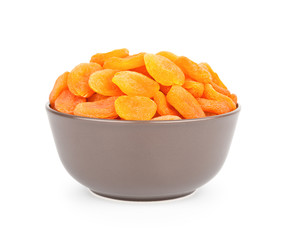 Bowl of delicious dried apricots isolated on white background