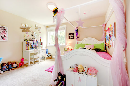 Baby girl room interior with white bed and pink curtains.