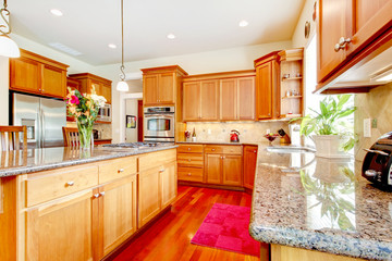 Wood luxury large kitchen with red and granite.