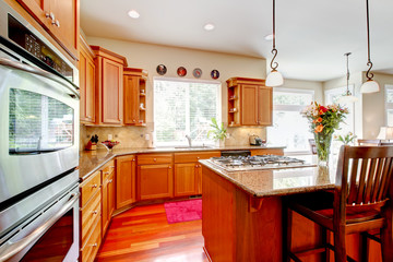 Wood luxury large kitchen with red and granite.