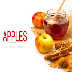 Honey jar and apples on white background
