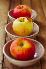 Naklejka na ściany i meble Apples in bowls on wooden table