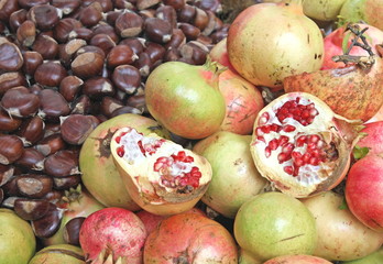 classic autumn fruits with many ripe chestnuts and pomegranates