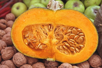 sweet orange pumpkin cut in half with the seeds of pumpkin