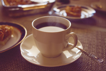 Coffee cup with cake on table