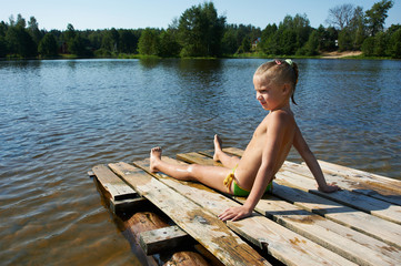 Little girl sits on a raft