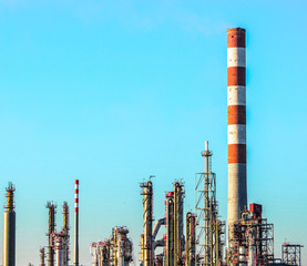 Oil refinery plant scene against blue sky