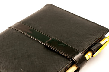 Black note book with ballpoint pen