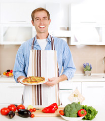 Young Man Cooking Pizza. Home. Kitchen