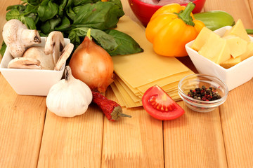 Vegetarian lasagna ingredients on wooden background