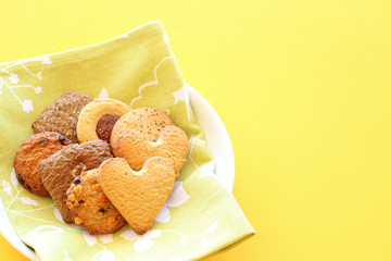 Assorted cookies on yellow background