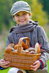 Season for mushrooms -  girl with basket of picked mushrooms