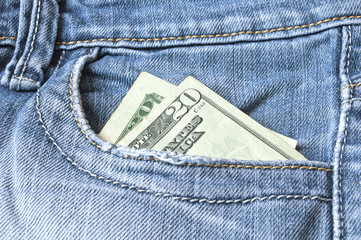 Blue jeans with american 20 dollar bill on its pocket