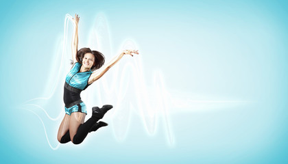 Young woman dancer. With lights effect.