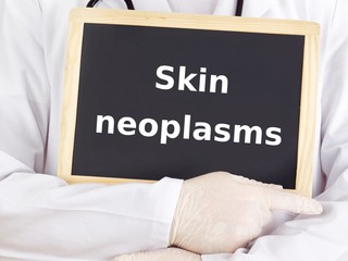 Doctor shows information on blackboard: skin neoplasms