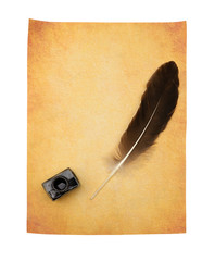 Feather pen on the old yellowed paper