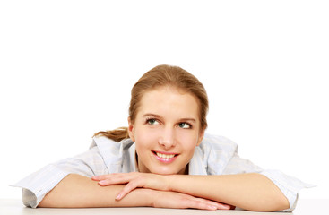 Obraz premium A pensive young woman at the desk