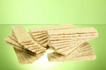tasty crispbread, on green background