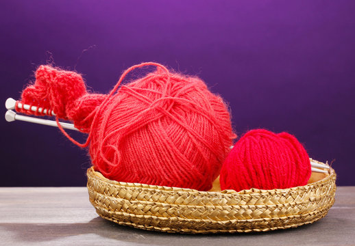 Red knittings yarns in basket