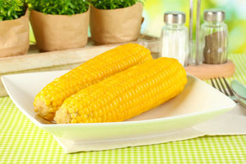 boiled corn and flowers on a background of nature