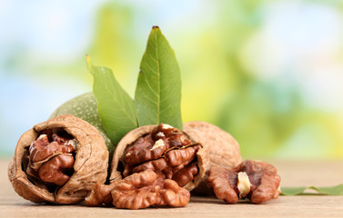 walnuts with green leaves, on green background