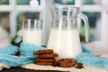 Pitcher and glass of milk with cookies
