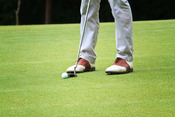 Golfer shooting a golf ball