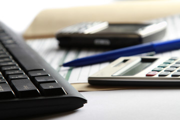 Cell and calculator on laptop