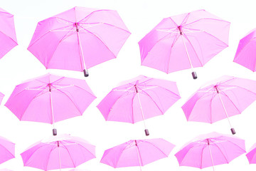 Pink umbrellas flying in the sky